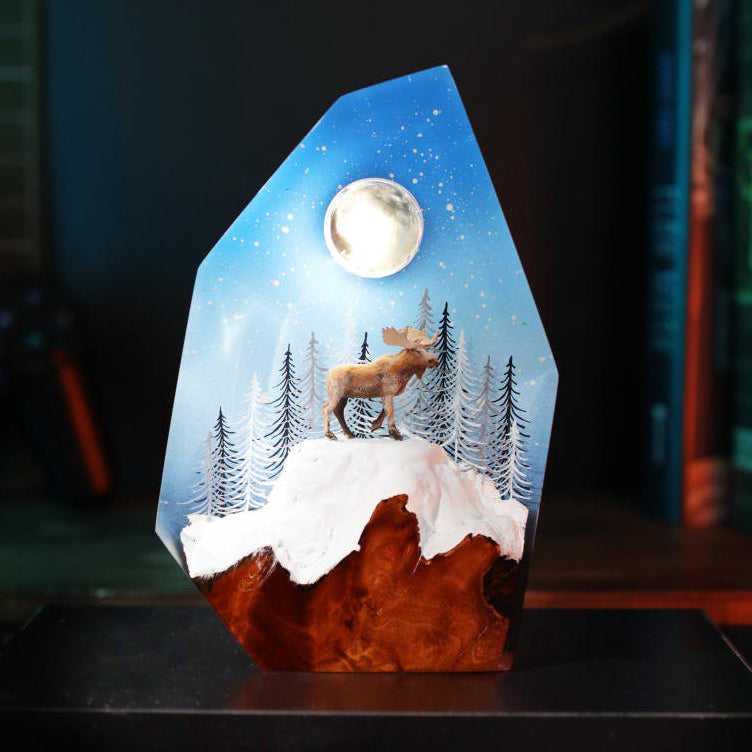 Reindeer in a winter forest lamp