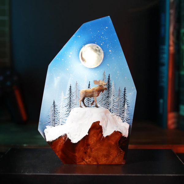 Reindeer in a winter forest lamp