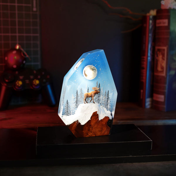 Reindeer in a winter forest lamp